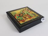 a small box with a painting on it on a table