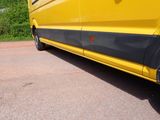 a yellow van that is parked on the side of the road
