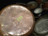a lot of pots and pans that are on the table