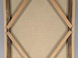 an old wooden frame with a wooden cross on it