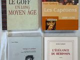 several books on a table with a white cloth on it