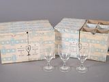 three wine glasses and a wine bottle in a box