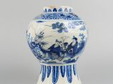 blue and white vase with a bird and flowers design on the lid