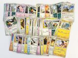a lot of pokemon cards that are on the table