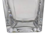 a glass vase that is sitting on a white surface