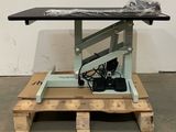a table that has a black top on a pallet