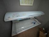 a white air conditioner sitting on top of a shelf