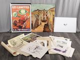 a lot of old postcards on the floor next to a laptop