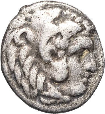 an old silver coin with a lion head on it