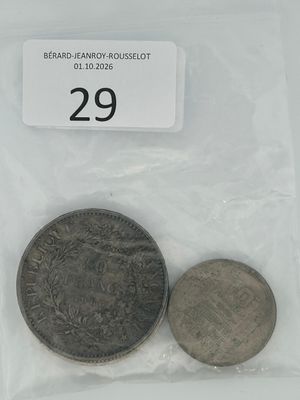 two coins in a plastic bag on a white surface