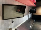 a picture of a kitchen with a red shelf above the sink