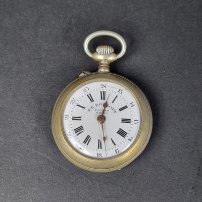 a gold pocket watch with roman numerals on the face