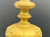 an image of a yellow vase with a bird on top