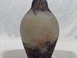 a brown and white vase sitting on a white surface