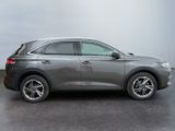 the grey car is parked in the parking lot on a cloudy day