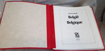 a book with a red cover sitting on a bed