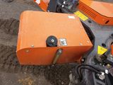 a small orange machine that is sitting on the ground