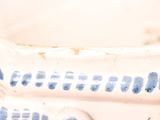 a close up of a blue and white vase with writing on it