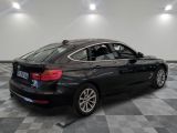 the back end of a black bmw car on a checkered floor