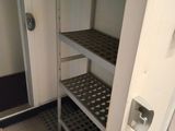a closet with shelves and a door in the room