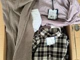 a box of men ' s shirts sitting on top of a table