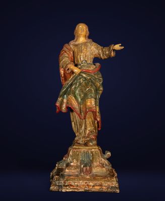 a wooden statue of a woman holding a child