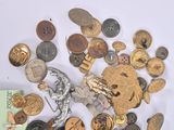 a pile of old buttons and other items on a table