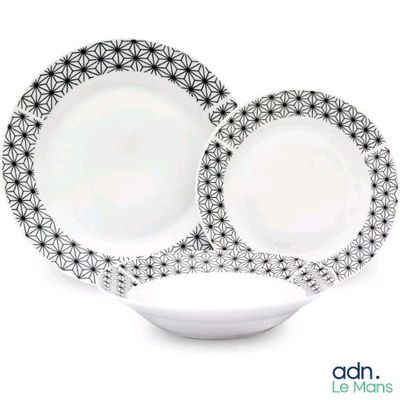 two plates with black and white designs on them on a white plate