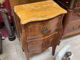 a wooden table with a marble top in a room