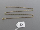 a close up of a gold chain with a price tag on it