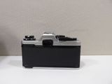 a black and silver camera sitting on a white table