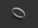 a white gold ring with diamonds on a black background