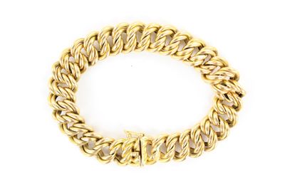 gros plan d'un bracelet en chaîne en or sur fond blanc