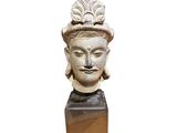 an image of a statue of a woman with a hat on her head