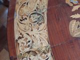 a wooden table with carvings on it in a room