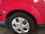 a close up of a red car with a flat tire