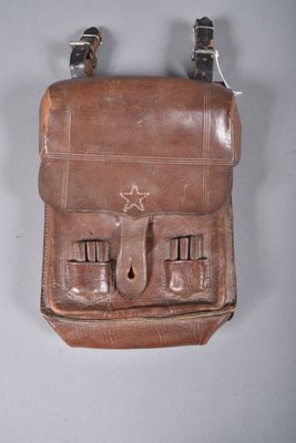 a brown leather bag with three compartments on it