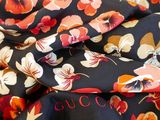 a close up of a floral print fabric with a red and white flower on it
