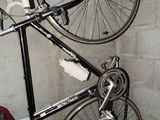 a bike that is hanging on the wall next to a bag