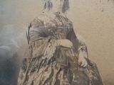 a picture of a woman in a dress sitting in a chair