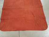 an orange rug sitting on the floor in a kitchen next to a sink