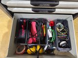a metal box with a bunch of wires and cords in it