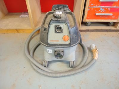 a vacuum that is sitting on the floor in the room