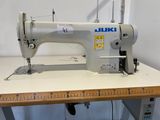 an image of a white sewing machine on a table