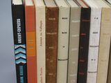 several books are stacked on top of each other on a table