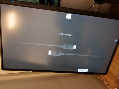 a flat screen tv sitting on top of a wooden table