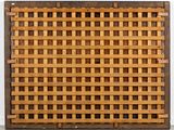 woven wooden basket on a table with a white wall in the background