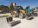 a backhoe of a tractor and a bulldozer in a construction site