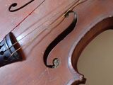 a close up of a violin that is on a table