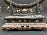a very ornate wooden bench with a mirror on it